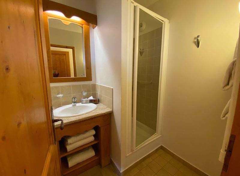 This cozy bathroom features a stylish vanity with a built-in sink and ample storage for towels.