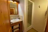 This cozy bathroom features a stylish vanity with a built-in sink and ample storage for towels.