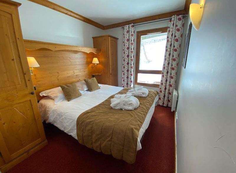 Cozy bedroom with a comfortable bed and warm lighting.