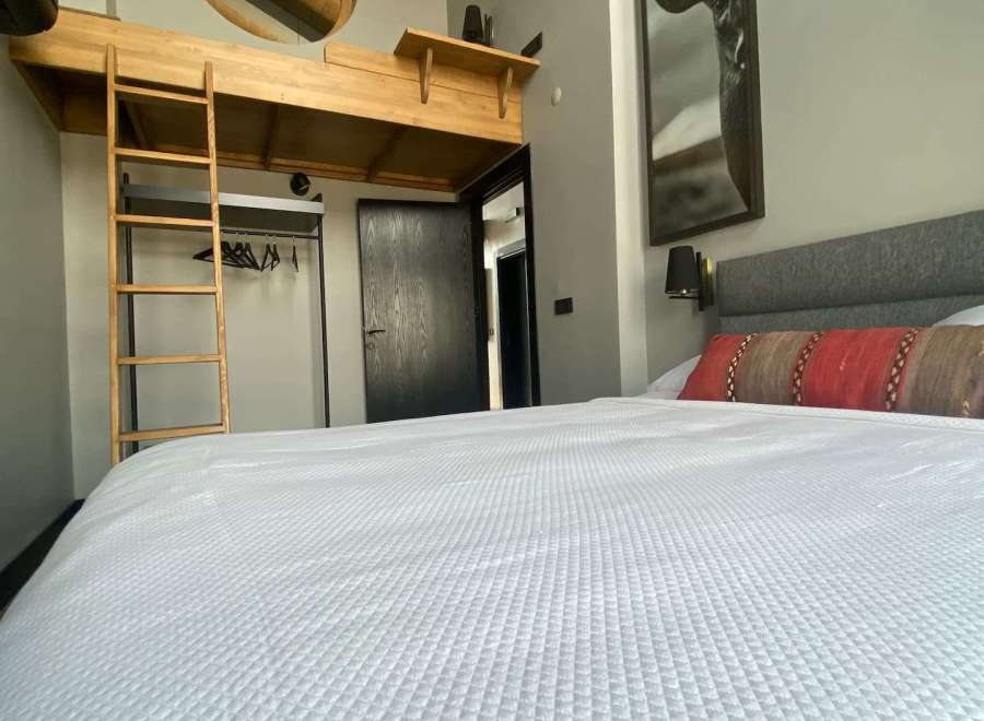 Discover a cozy retreat with a unique loft bed design, perfect for a stylish stay.