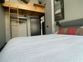 Discover a cozy retreat with a unique loft bed design, perfect for a stylish stay.