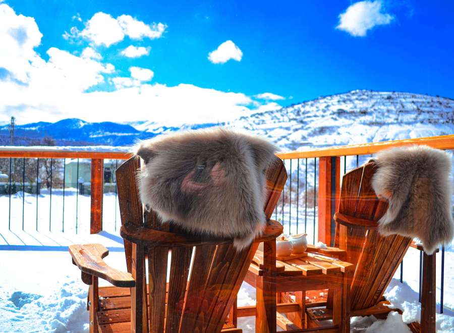 Enjoy the stunning mountain views from this cozy outdoor space.