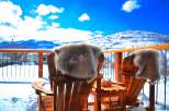Enjoy the stunning mountain views from this cozy outdoor space.