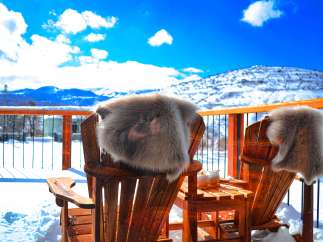 Enjoy the stunning mountain views from this cozy outdoor space.