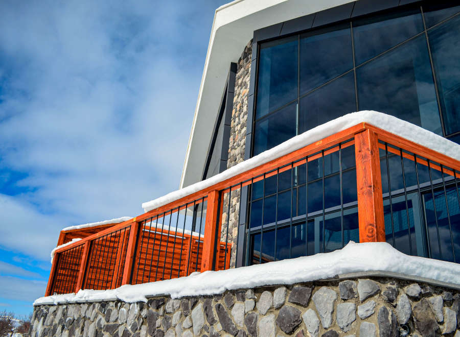 This stunning property boasts a modern design with a unique stone facade and a striking glass facade.