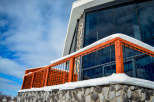 This stunning property boasts a modern design with a unique stone facade and a striking glass facade.