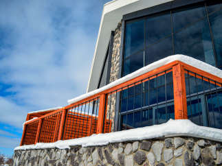 This stunning property boasts a modern design with a unique stone facade and a striking glass facade.