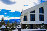 This stunning modern home boasts a sleek white exterior and unique architectural details.