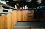 Modern kitchen design with sleek black countertops and cabinetry.