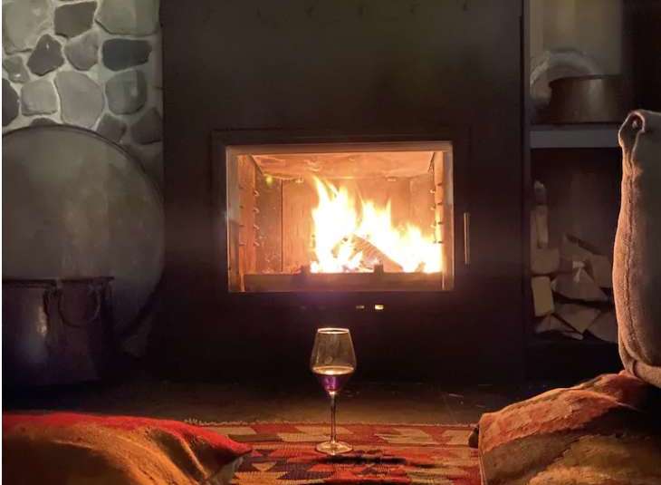 Cozy up in front of the fireplace in this inviting space.