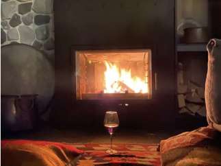 Cozy up in front of the fireplace in this inviting space.