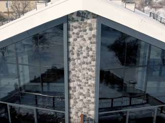 This stunning property boasts a unique architectural design with expansive glass windows, offering breathtaking views.