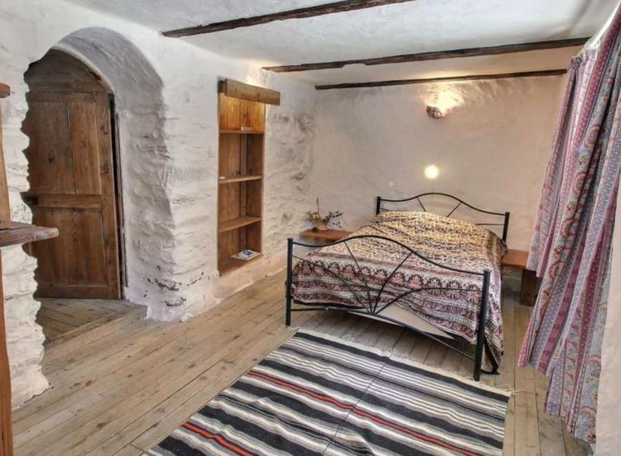 Rustic Charm Meets Modern Comfort in this Unique Bedroom.