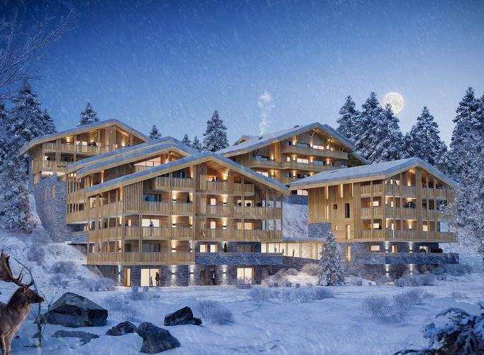 Experience the ultimate winter escape in these stunning wooden chalets nestled in a snowy landscape.