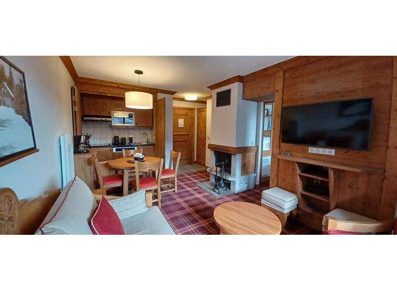 Cozy up in this charming apartment featuring a warm fireplace and rustic wooden accents.