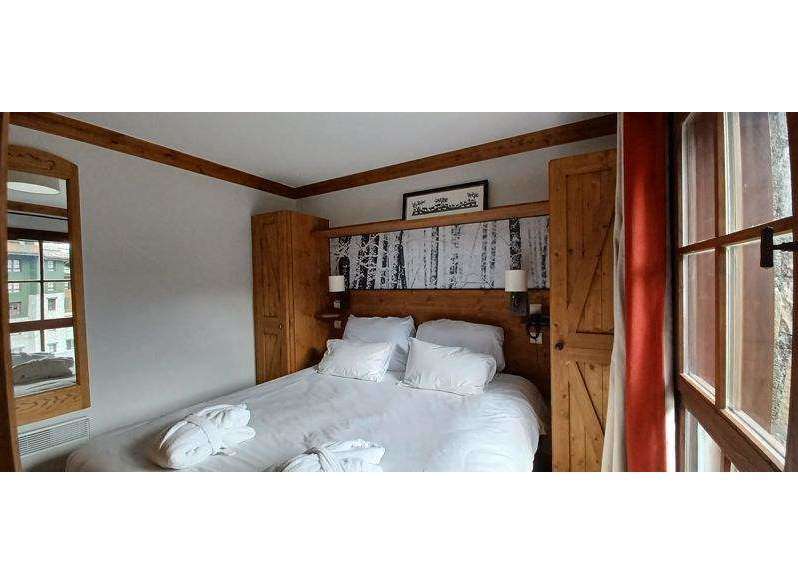 Cozy up in this charming bedroom featuring a comfortable bed and inviting ambiance.