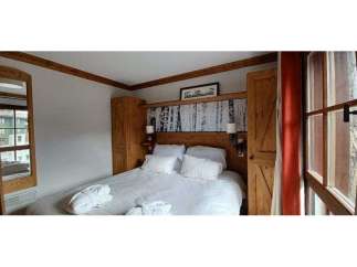 Cozy up in this charming bedroom featuring a comfortable bed and inviting ambiance.