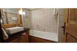 Discover a cozy bathroom with a bathtub and shower combination.