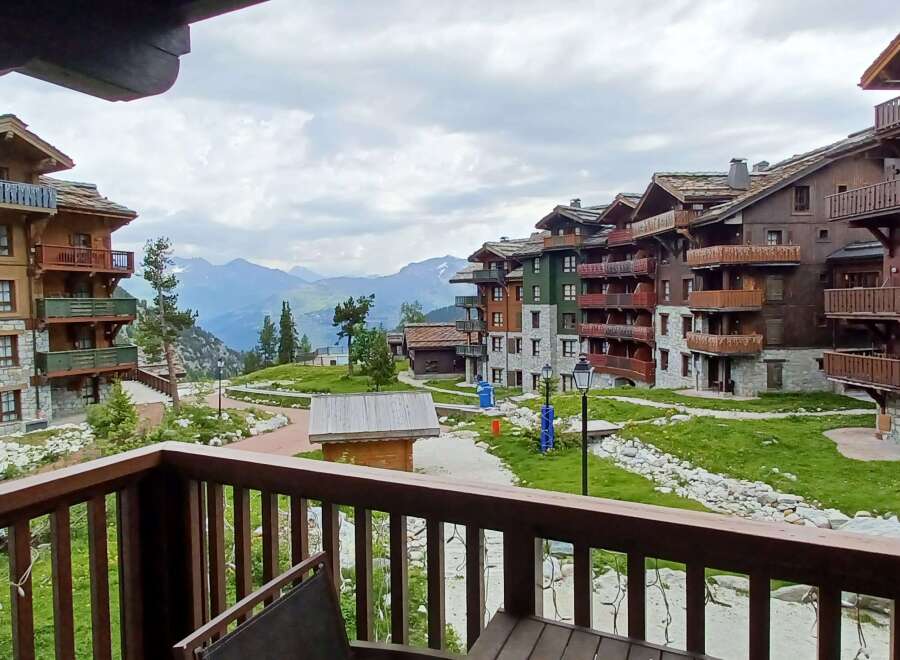 Experience mountain living in this stunning alpine village featuring charming wooden chalets with stone accents and private balconies offering breathtaking views.
