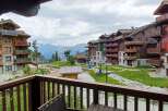 Experience mountain living in this stunning alpine village featuring charming wooden chalets with stone accents and private balconies offering breathtaking views.