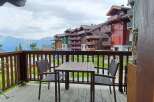 Enjoy breathtaking mountain views from this charming balcony, complete with a table and chairs for al fresco dining.