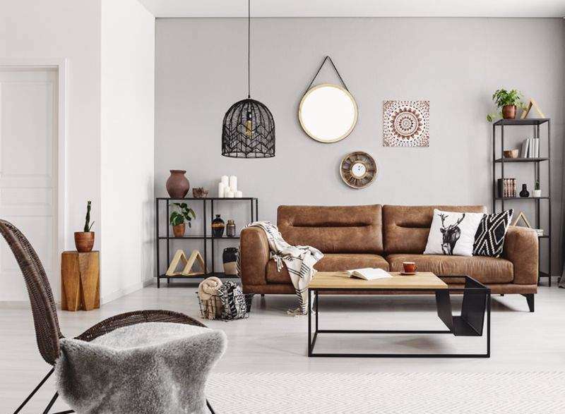 This cozy living room features a stylish brown leather sofa, perfect for relaxing.