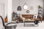 This cozy living room features a stylish brown leather sofa, perfect for relaxing.