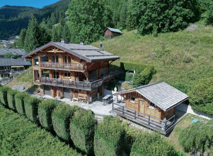 Discover a stunning wooden chalet nestled in a picturesque mountain setting.