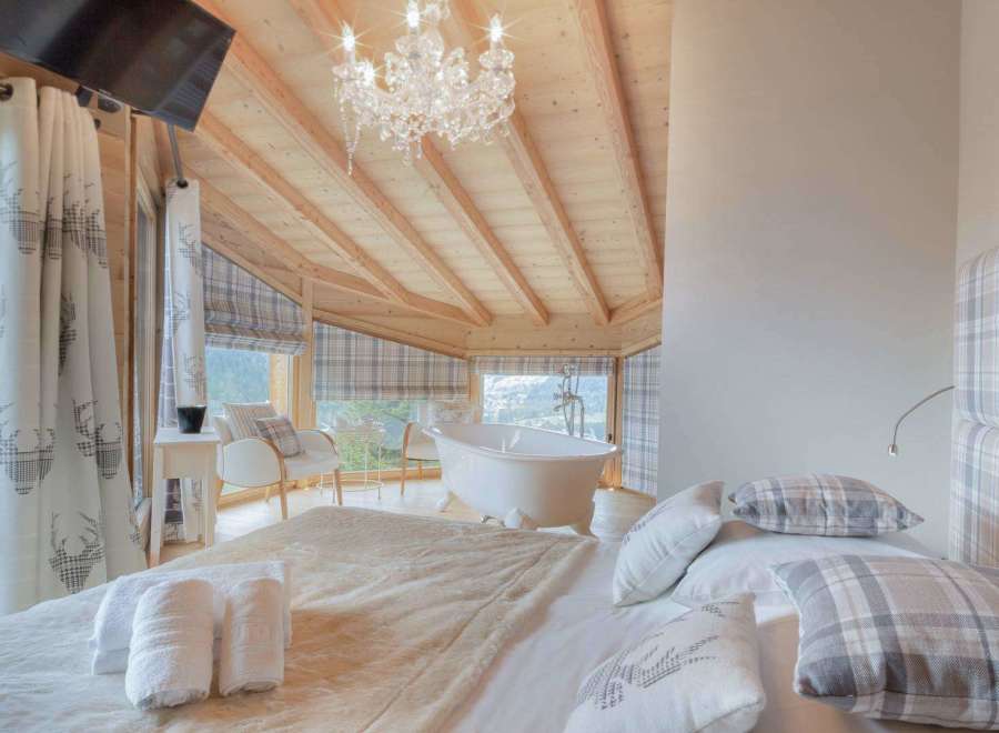Experience luxury in this stunning bedroom with a breathtaking mountain view.