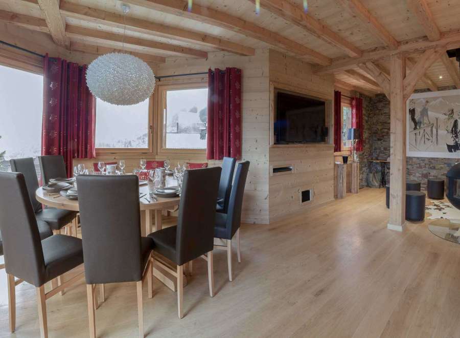 Experience luxury living in this stunning property, featuring a cozy dining area perfect for gatherings.
