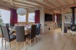 Experience luxury living in this stunning property, featuring a cozy dining area perfect for gatherings.