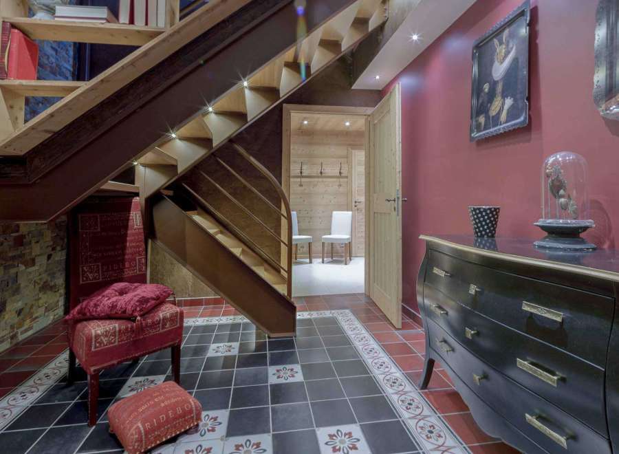 This stunning property features a beautifully designed staircase with integrated lighting, creating a warm and inviting atmosphere.