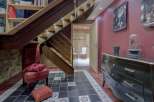 This stunning property features a beautifully designed staircase with integrated lighting, creating a warm and inviting atmosphere.