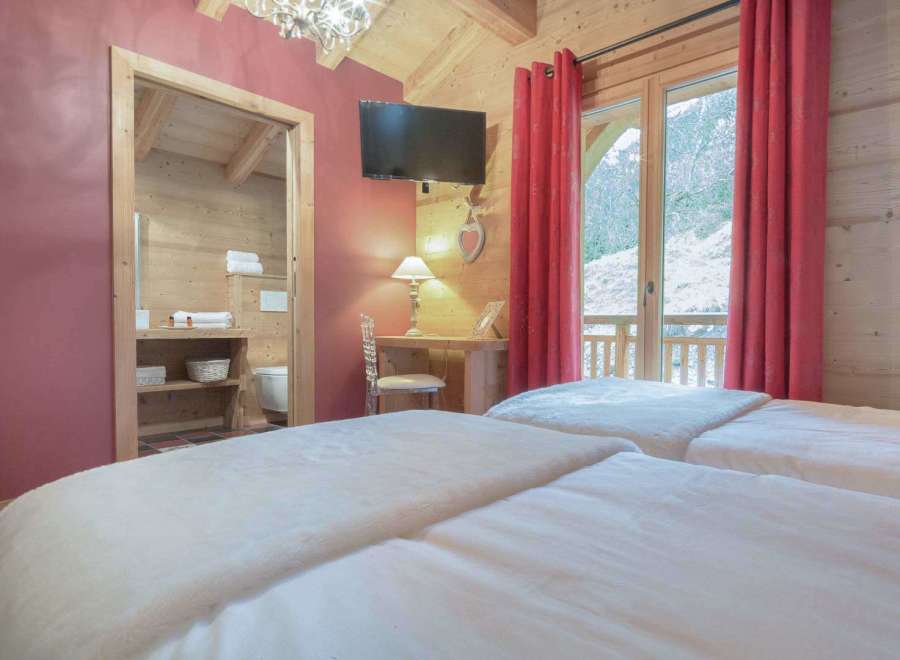 Experience the charm of this cozy bedroom, featuring a warm wooden interior and a touch of rustic elegance.