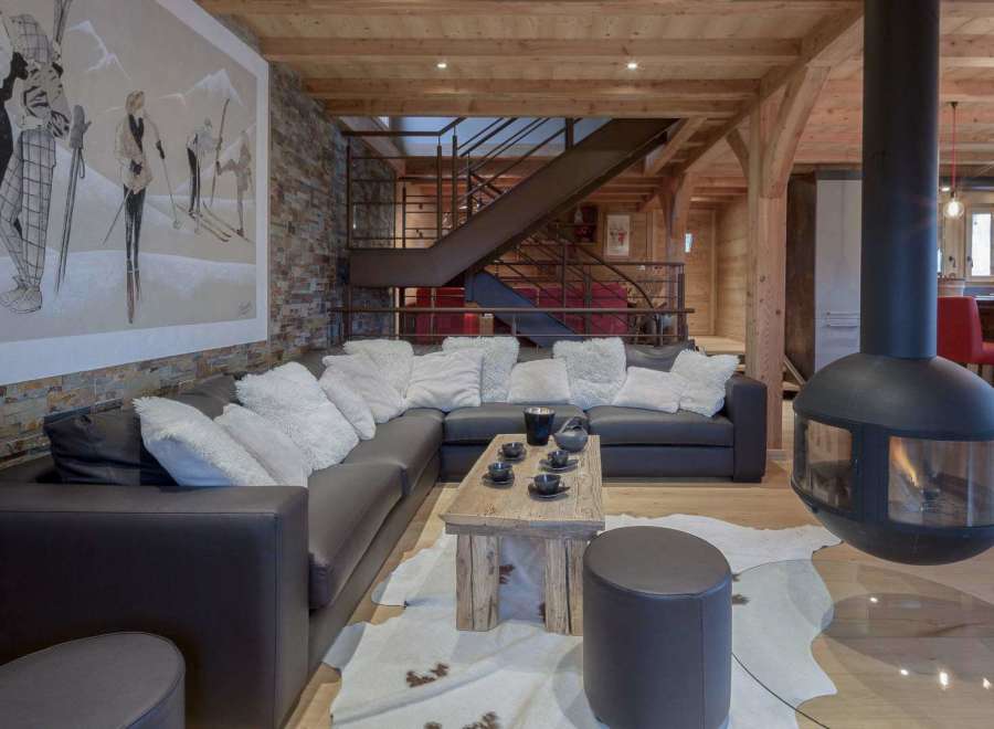 Experience luxury living in this stunning property, featuring a cozy living room with a modern fireplace and a comfortable sectional sofa.