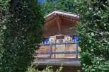 Discover the charm of this wooden chalet nestled amidst lush greenery.