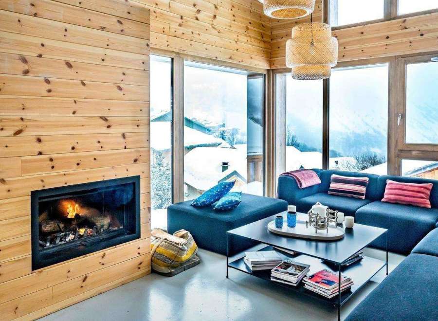 Cozy up in this stunning living room with a fireplace and breathtaking mountain views.