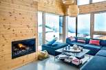 Cozy up in this stunning living room with a fireplace and breathtaking mountain views.