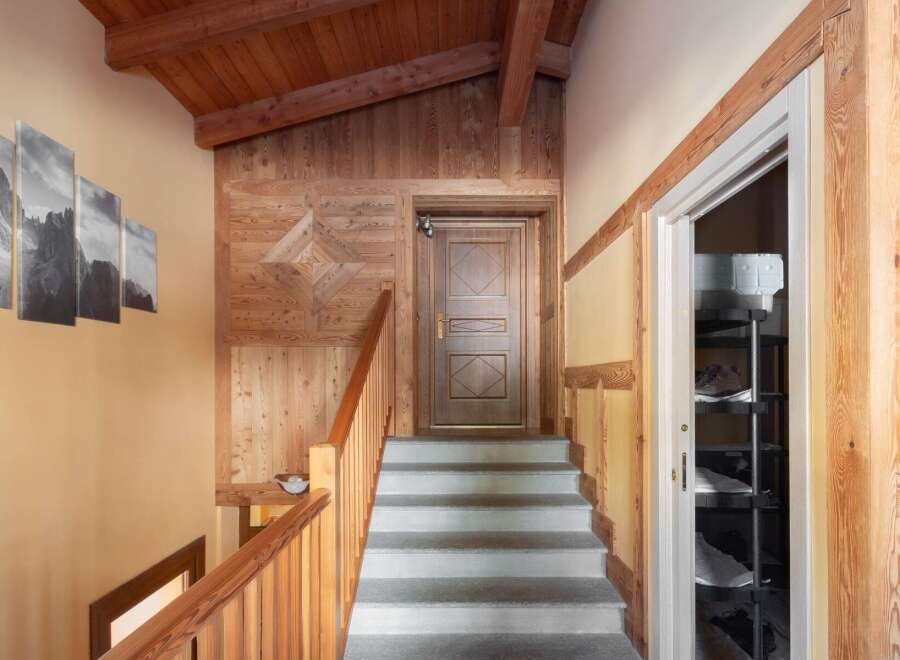 This stunning property boasts a warm and inviting interior with beautiful wooden accents throughout.