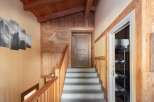 This stunning property boasts a warm and inviting interior with beautiful wooden accents throughout.