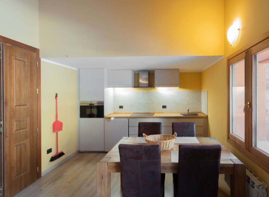 This charming kitchen features a modern design with sleek cabinetry and a cozy dining area.