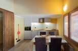 This charming kitchen features a modern design with sleek cabinetry and a cozy dining area.