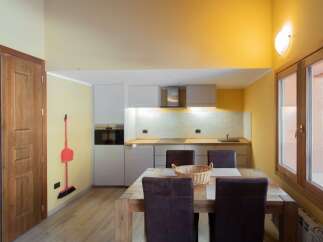 This charming kitchen features a modern design with sleek cabinetry and a cozy dining area.