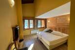 Cozy bedroom with wooden accents and a comfortable bed.