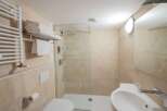 This modern bathroom features a sleek design with a walk-in shower and a stylish sink.