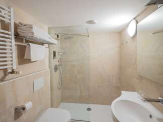 This modern bathroom features a sleek design with a walk-in shower and a stylish sink.
