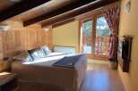 Cozy up in this charming bedroom with its rustic wooden accents and inviting ambiance.