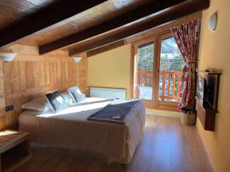Cozy up in this charming bedroom with its rustic wooden accents and inviting ambiance.