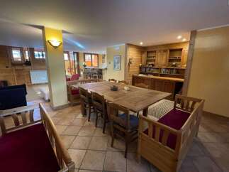 This cozy dining area features a large wooden table perfect for gatherings.