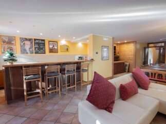 This property boasts a stylish bar area, perfect for entertaining guests.